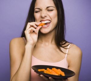 BJRMCW Woman eating carrot sticks